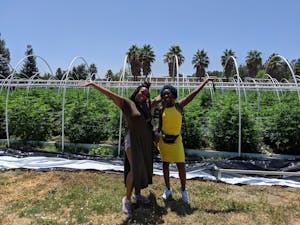 Two women in front of weed plants on one of the pot farms in California's Emerald Triangle