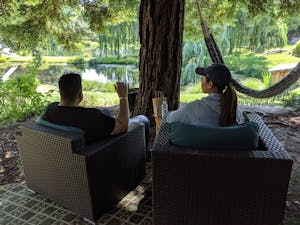 Two cannasseurs relaxing by a willow pond imbibing