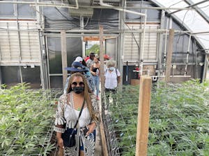 California Equity Grant participants enter a greenhouse on a weed tour