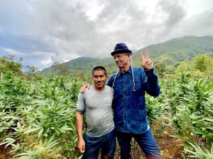 Steve DeAngelo in a cannabis field with a weed farmer