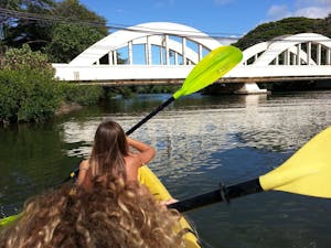 Kayaking in front of bridge at Haleiwa
