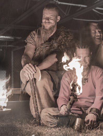 men in costume around a fire