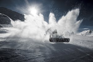 A snowboarder skidding in the snow