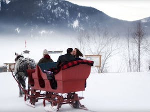 Bride and groom on sleigh ride