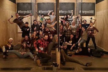 A group of people posing for a picture during the axe throwing league