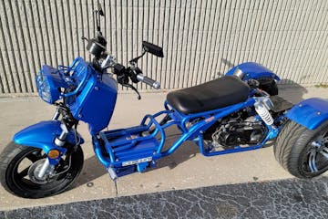 a motorcycle parked in front of a blue wall
