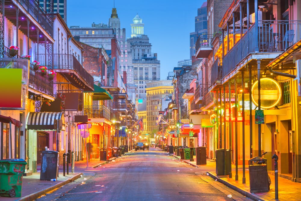 Bourbon St, New Orleans, Louisiana, USA cityscape of bars and retaurants at twilight.
