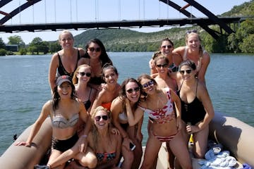 girls partying on a pontoon boat on the lake