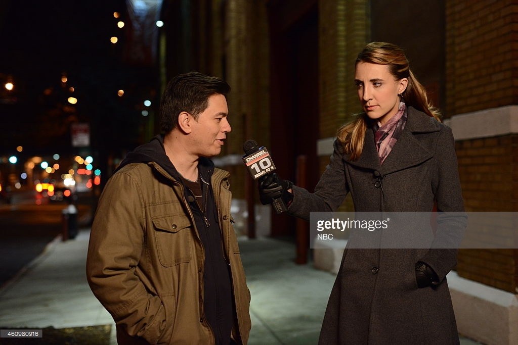 THE MYSTERIES OF LAURA -- "The Mystery of the Fateful Fire" Episode 112 -- Pictured: (l-r) Max Jenkins as Max Carnegie, Elyse Brandau as reporter -- (Photo by: Nicole Rivelli/NBC/NBCU Photo Bank)