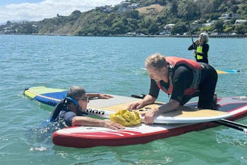 Learn different ways to get back on your board if you fall off, and assist rescue others in trouble from your paddleboard on our Paddle Nelson safety course