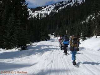 winter hikers in snowshoes hiking a snowy trail in the Cascades