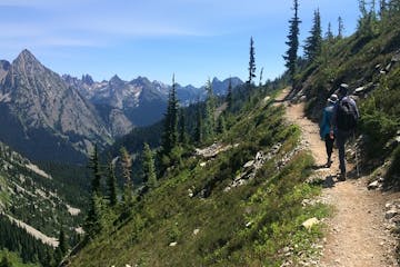 two hikers with a view of rugged peaks in North Cascades National Park