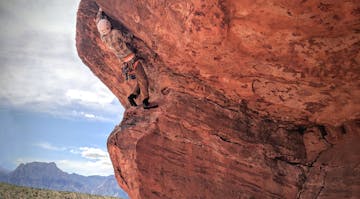 a climber climbing a steep overhang during a Kaf multipitch climbing course in Red Rock, Nevada