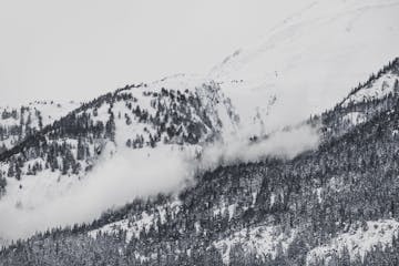 a snow-covered mountain after an avalanche scours its slopes