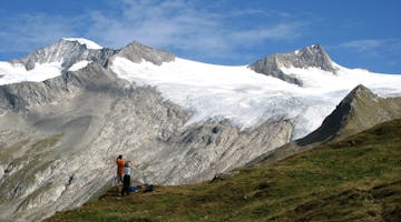 hikers on a Kaf international trip beneath a huge glacier near Grossvenediger, Austria