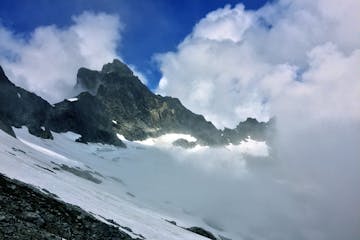 glacier and clouds enveloping Mount Triumph