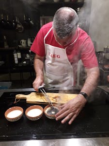 a man cooking in a kitchen preparing Leite Creme