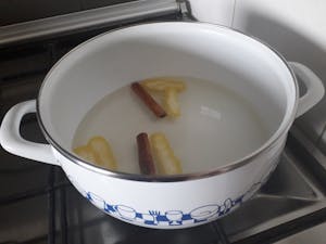 a bowl of lemon and cinnamon Portuguese Rice Pudding