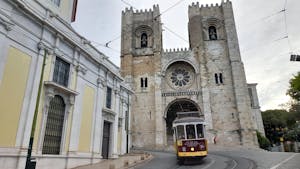 cathedral and yellow tram in lisbon