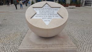 a sign in front of a statue jewish tours portugal