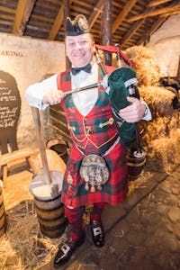 A Scottish bagpiper at Burns Cottage