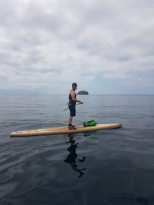 a man on a stand up paddle board on Tralee Bay