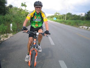 a man riding a bicycle on a road