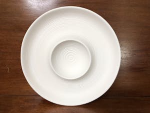 a white plate on a wooden surface