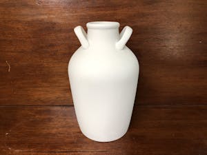a white vase on a table