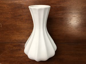 a white vase on a table