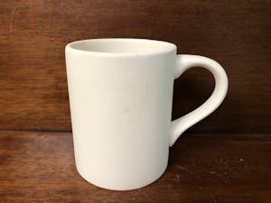 a close up of a coffee cup sitting on a table
