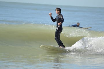 a person in a wet suit is surfing on a wave in the ocean