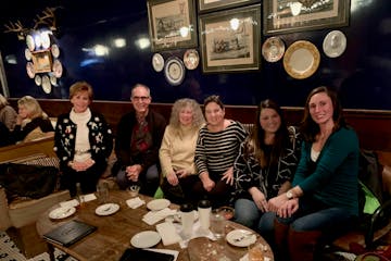 a group of people sitting at a table posing for the camera