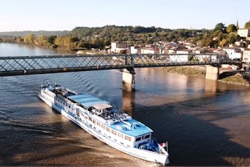 a boat traveling across a bridge over a body of water