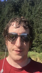 a man wearing sunglasses taking a selfie