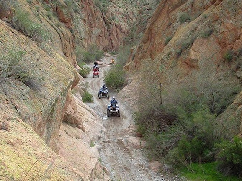 People riding on ATVs through Box Canyon in Arizona