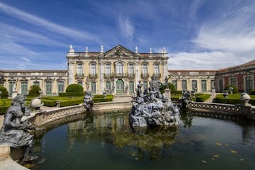 a castle on Palace of Queluz over a body of water