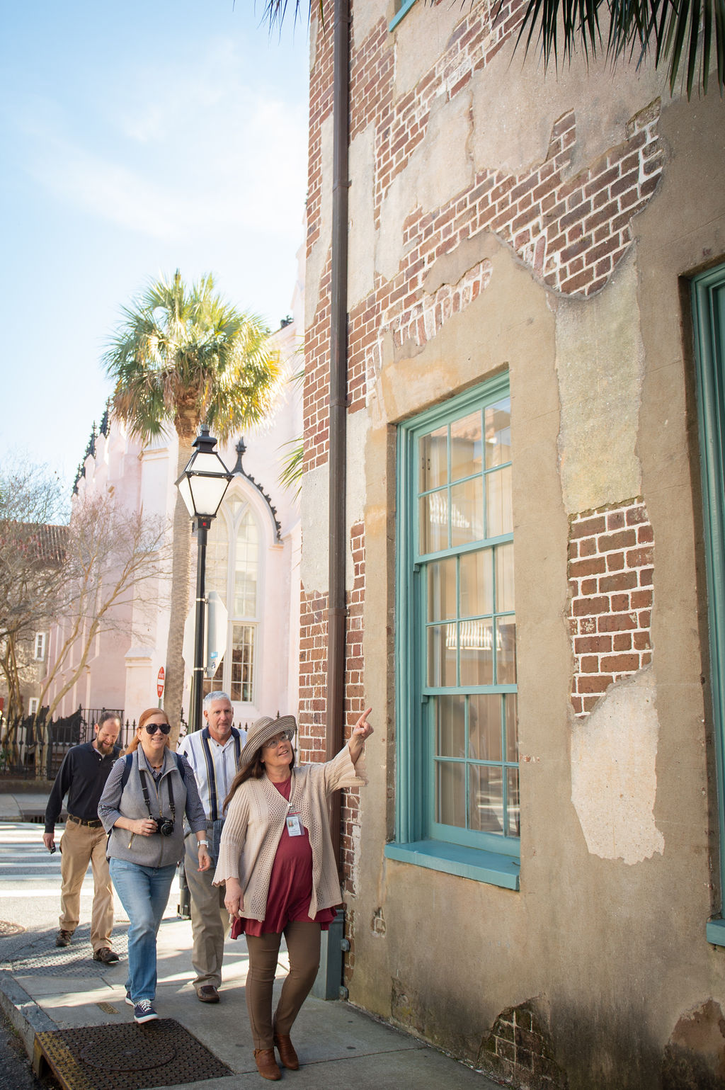 a group of people walking in front of a building