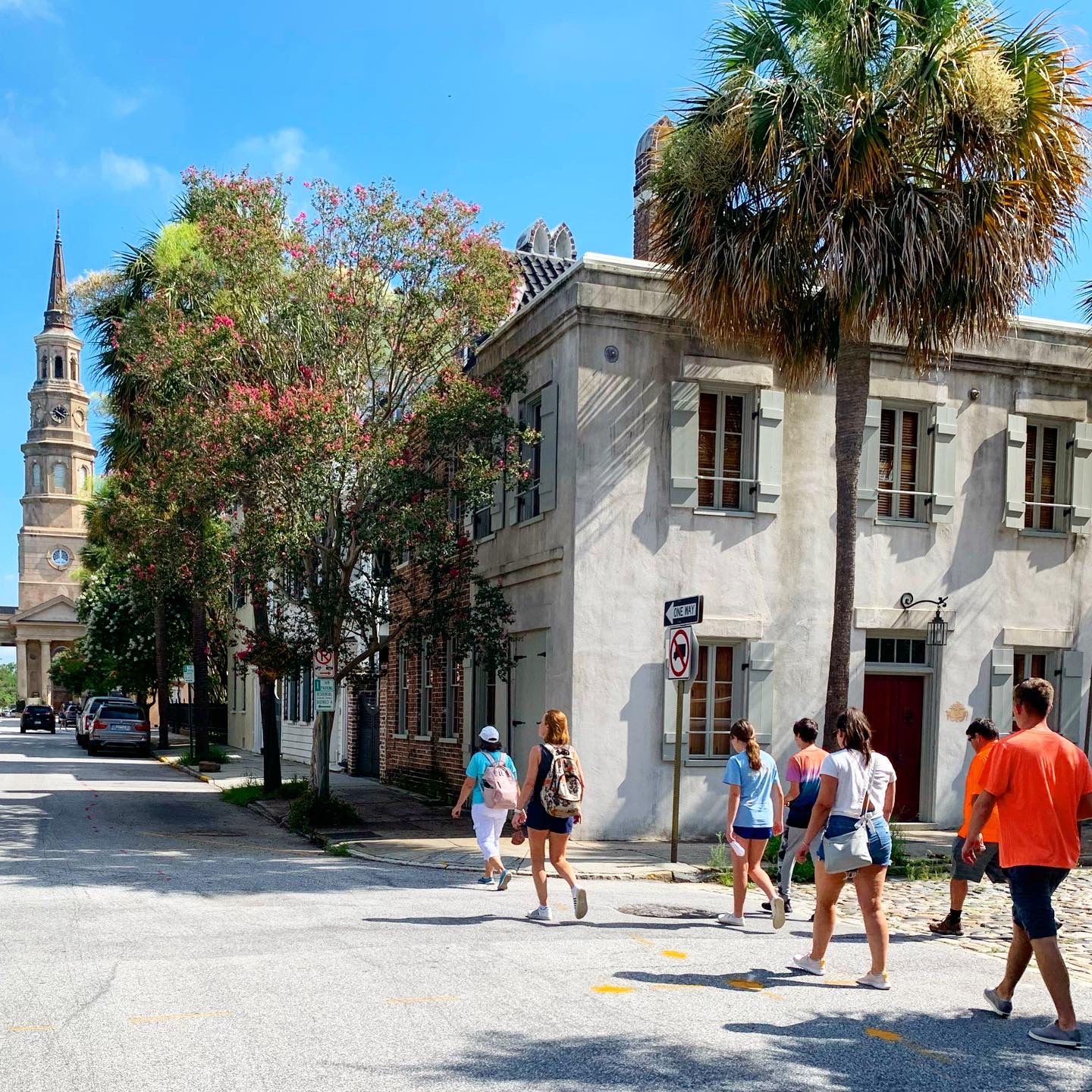 a group of people walking down the street in front of a building