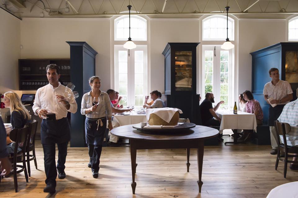 a group of people standing around a living room