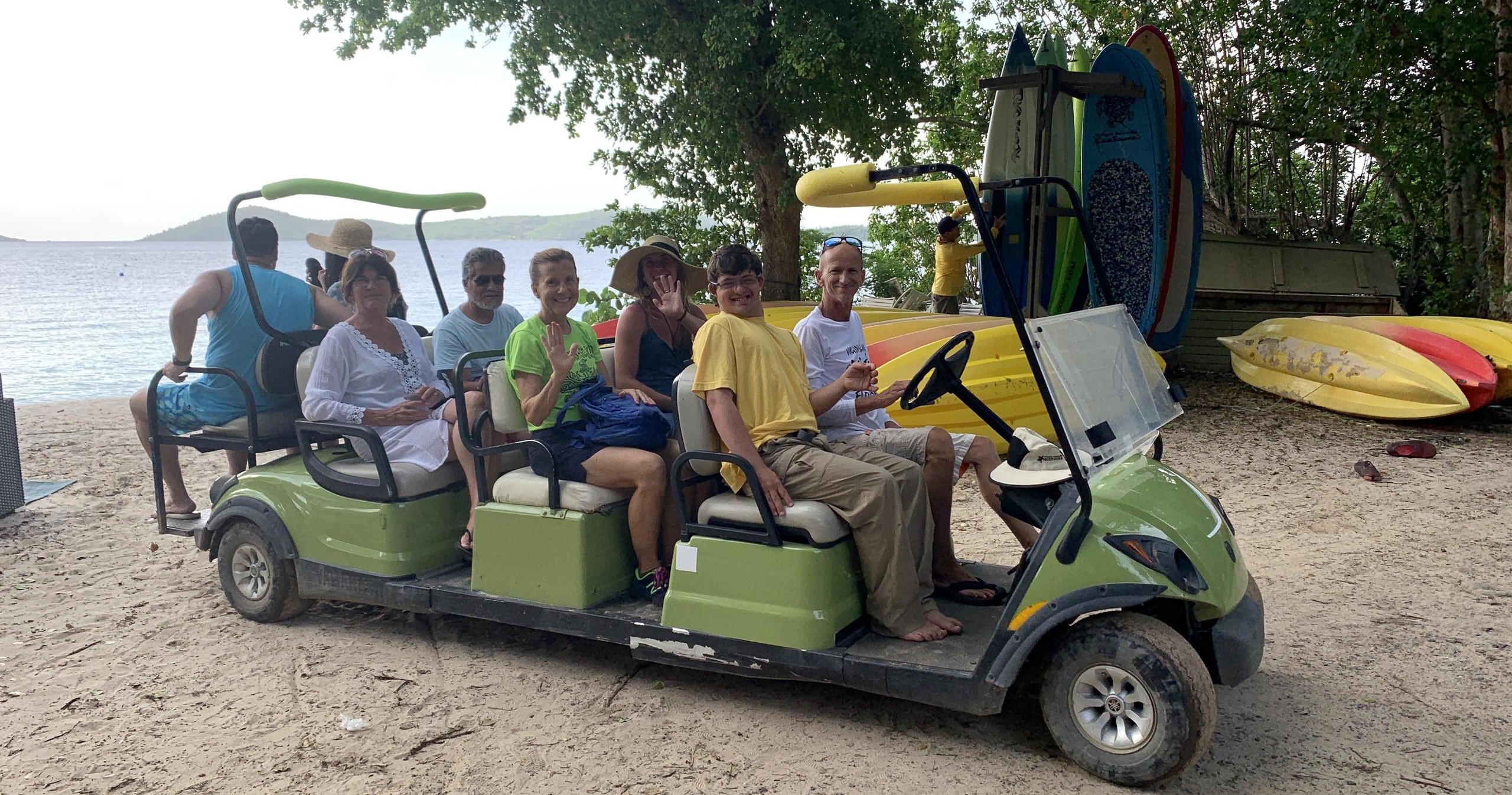 a group of people sitting around a car