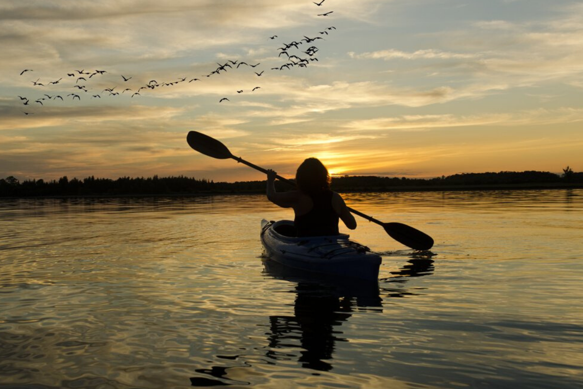 a man flying through the air over a body of water