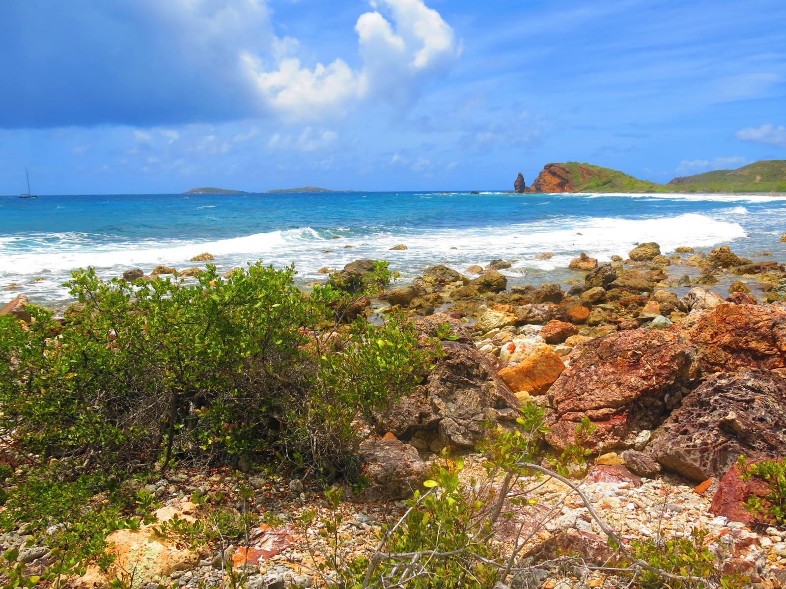 a rocky beach next to a body of water