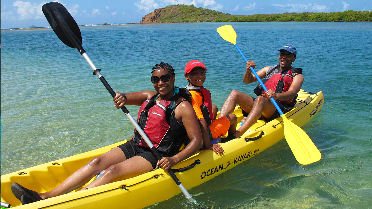 a group of people in a boat on a body of water