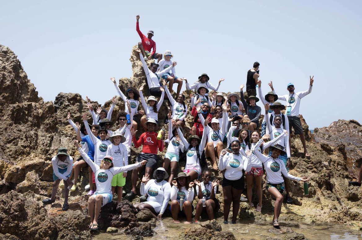 a group of people on a rocky beach