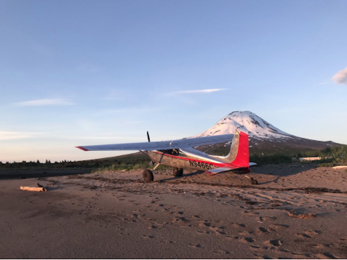 a plane sitting on top of a dirt field