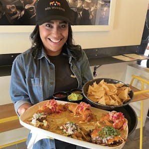 a person standing in front of a tray of food