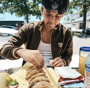 a person sitting at a table with food