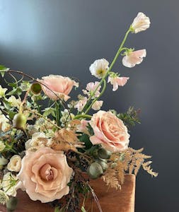 a bouquet of flowers in a vase on a table