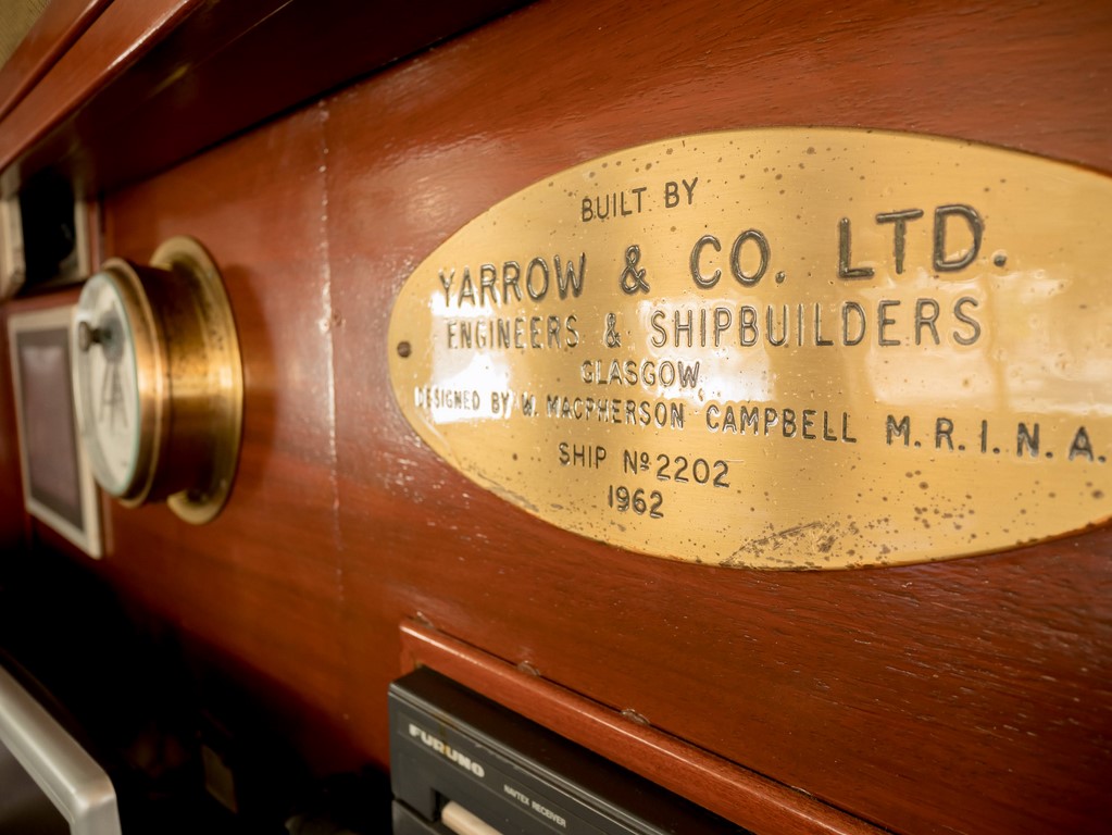 a golden plate fixed on the bridge where the shipyard stamped the data of the boat